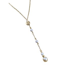 Collier de dos doré et perles baroques